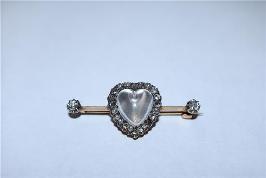 A diamond and moonstone bar brooch, heart-shaped setting in yellow metal (one stone missing), boxed 40mm.